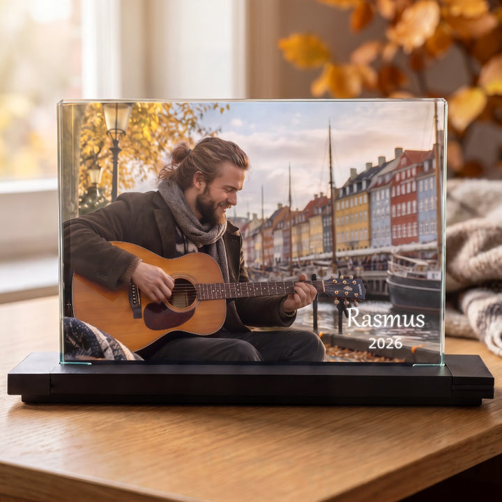 Kristallfotoram med färgtryck av man med gitarr vid Nyhavn och text, på svart fot